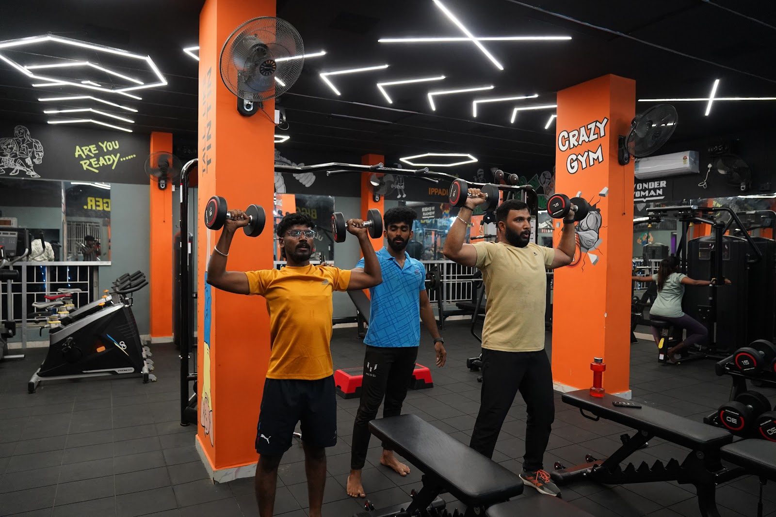 Members training with dumbbells at Zenith Fitness Club